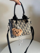 cross bag with bear charm